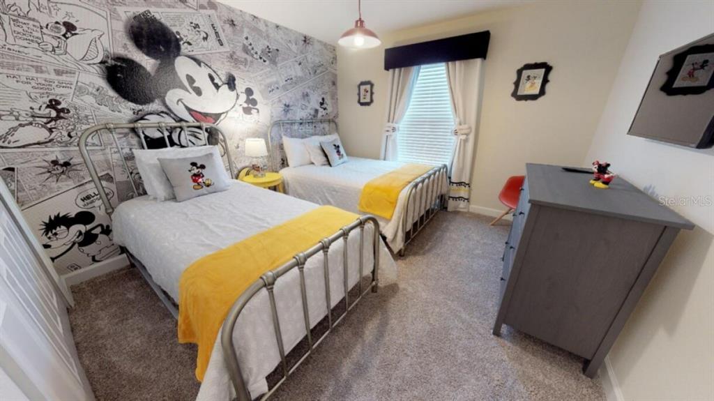 A bedroom features two twin beds, a Mickey Mouse mural, and a gray dresser — 4968 WINDERMERE AVENUE, KISSIMMEE, FL