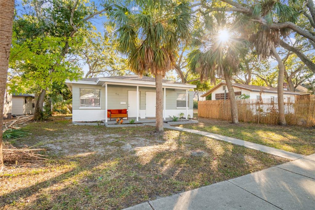 A single-story house with a light green exterior, white trim, and a small front porch — 610 16TH AVENUE S, ST PETERSBURG, FL