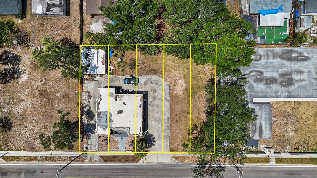 An aerial view shows a building and adjacent vacant lots outlined in yellow along a road — 6719 S WEST SHORE BOULEVARD, TAMPA, FL