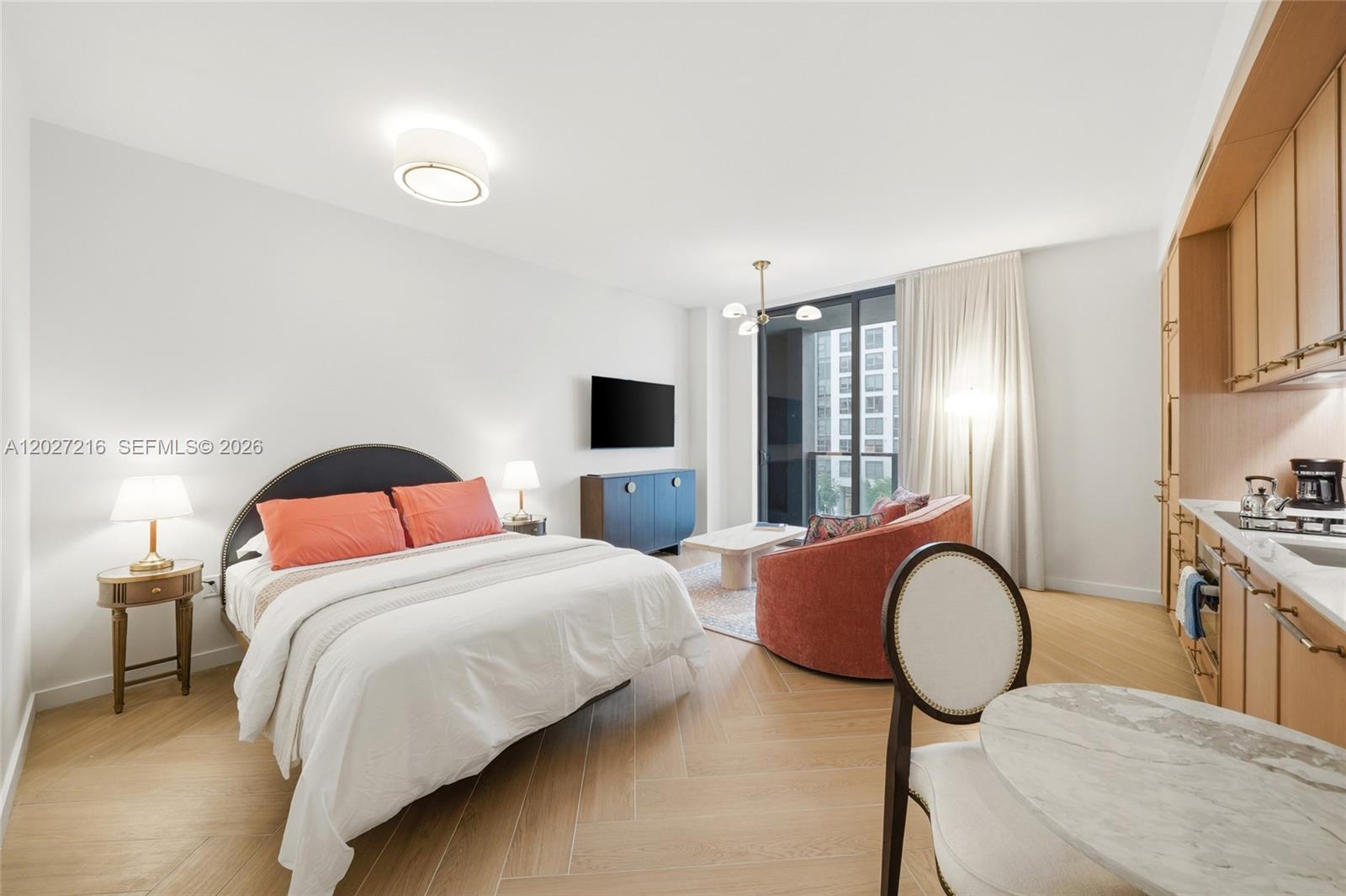 A studio apartment features a bed, a small seating area, and a kitchenette — 2700 NW 2nd Ave # 345, Miami FL 33127, MIAMI, FL