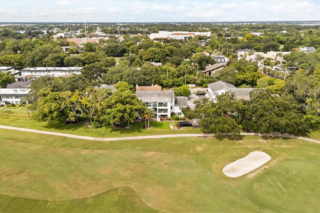 An aerial view shows a multi-story building situated along the edge of a golf course — 494 W PAR STREET, ORLANDO, FL