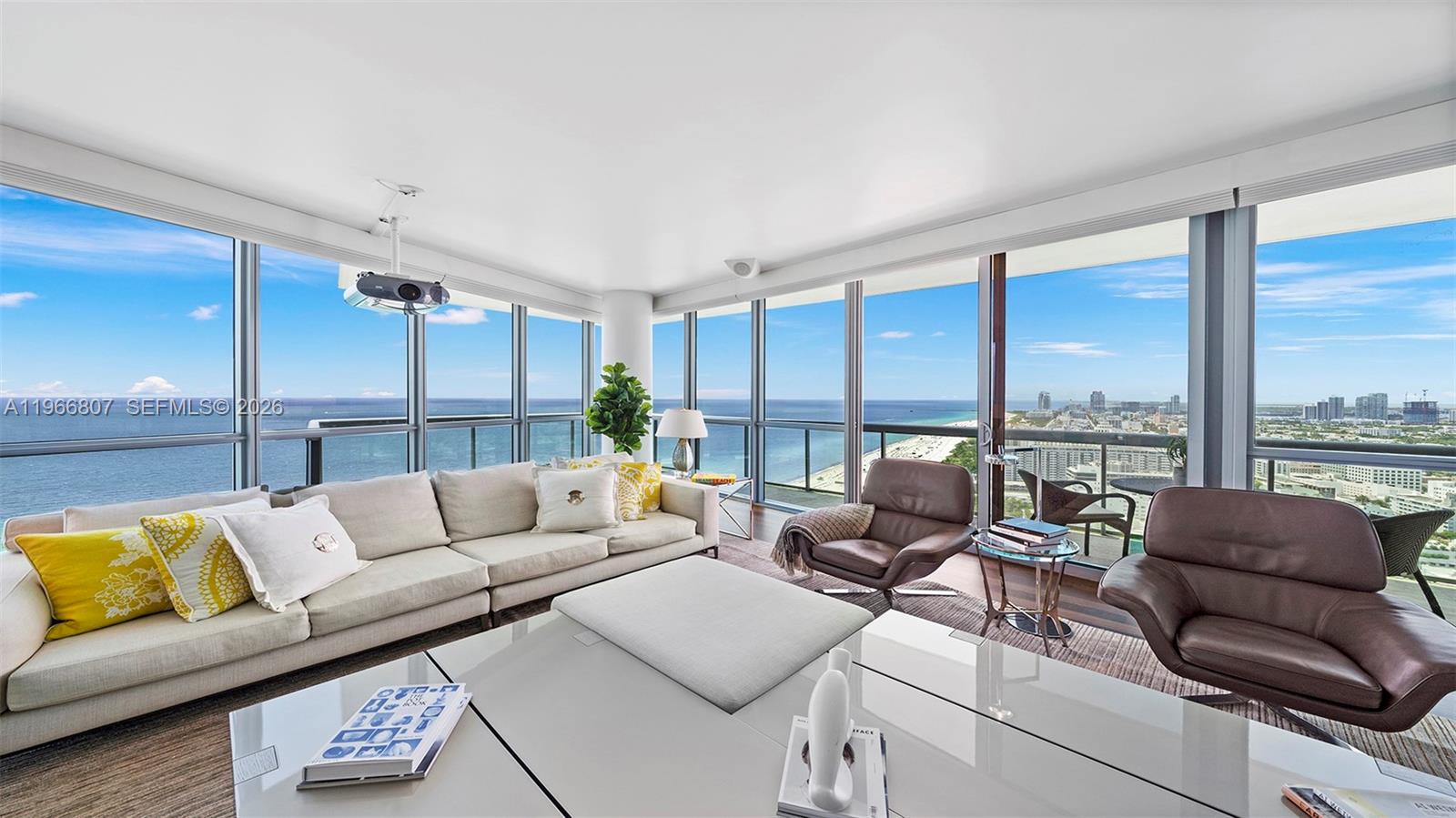 A living room features floor-to-ceiling windows with panoramic ocean and city views — 101 20th St # 3909, Miami Beach FL 33139, MIAMI BEACH, FL
