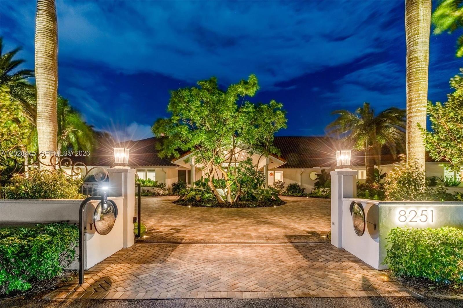 A paved circular driveway leads to the entrance of a house with palm trees — 8251 Old Cutler Rd, Coral Gables FL 33143, CORAL GABLES, FL