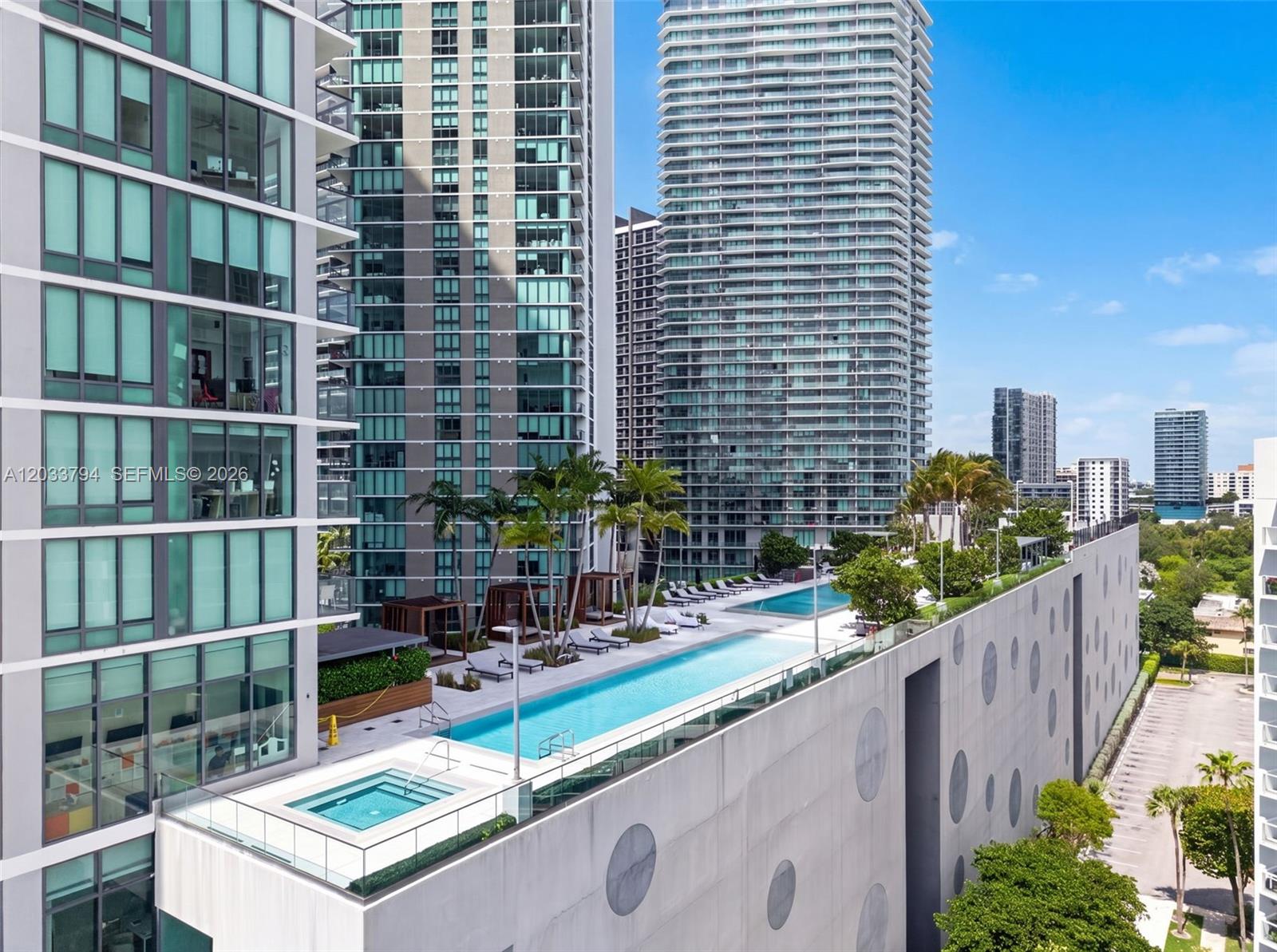 An elevated outdoor pool deck features a lap pool, a hot tub, and lounge chairs — 3131 NE 7th Ave # 2605, Miami FL 33137, MIAMI, FL