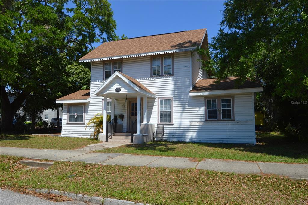 A two-story white house with a gabled roof and a covered front porch — 811 18TH AVENUE S, ST PETERSBURG, FL