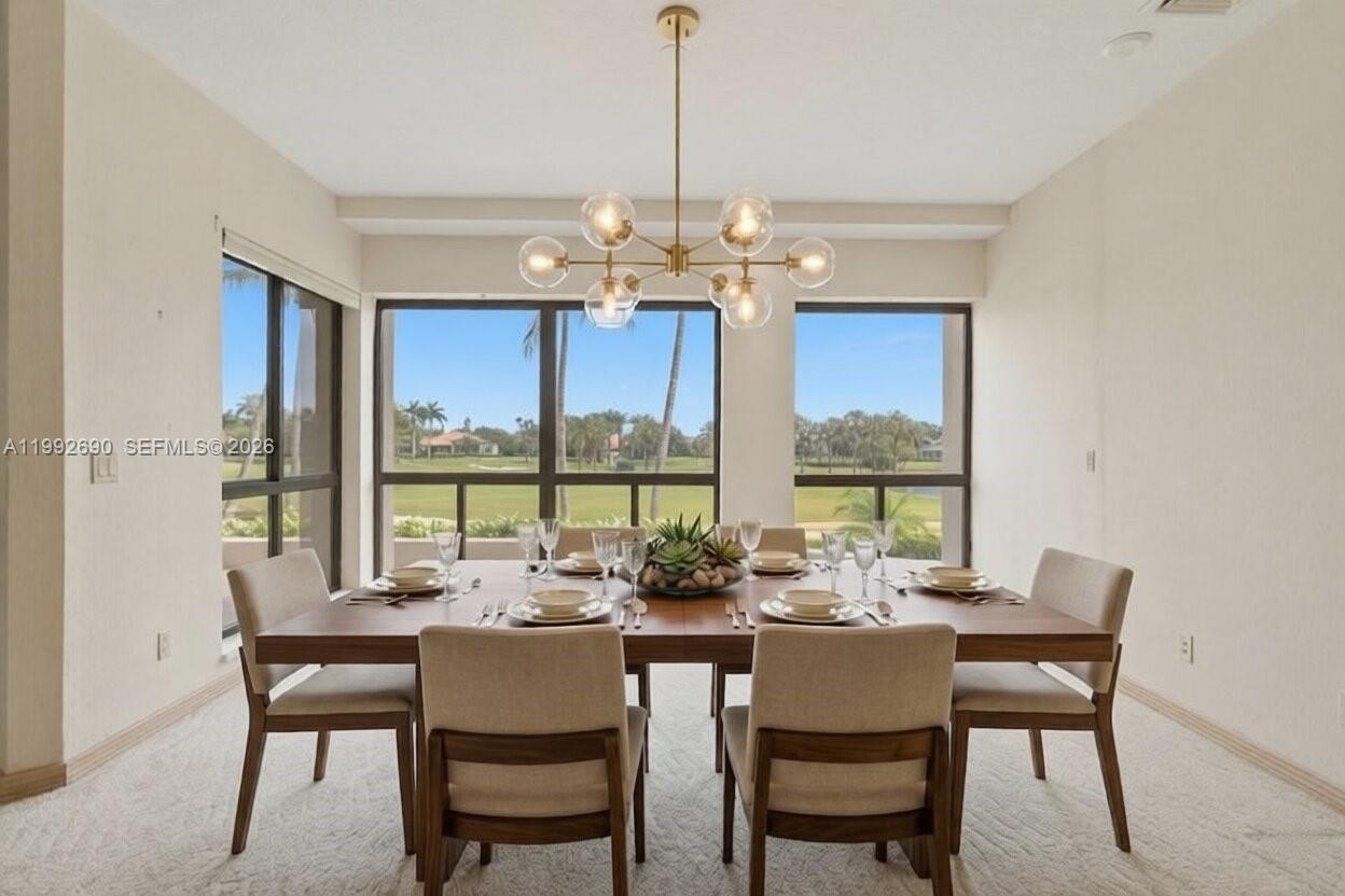 A dining room features a modern chandelier, a wooden table with six chairs, and windows — 7383 Orangewood Ln # 301, Boca Raton FL 33433, BOCA RATON, FL