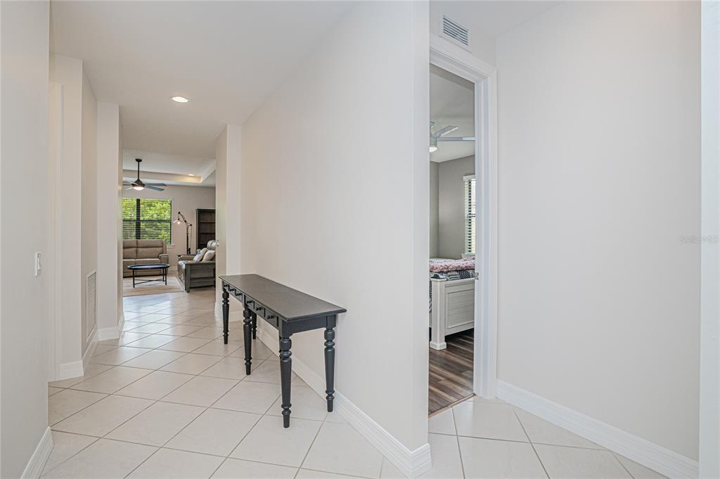 A kitchen features dark wood cabinets, granite countertops, a center island, and stainless steel appliances — 2599 SHERMAN OAK DRIVE, NORTH PORT, FL