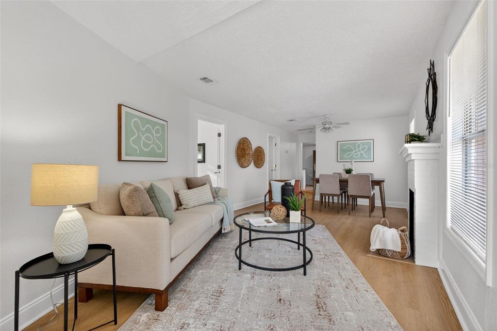 A living room features a beige sofa, a glass coffee table, and a dining area — 1777 28TH AVENUE N, ST PETERSBURG, FL