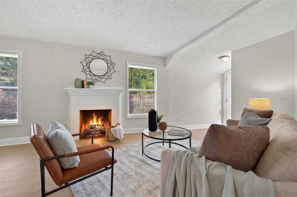 A living room features a white brick fireplace, a leather armchair, and a beige sofa — 1777 28TH AVENUE N, ST PETERSBURG, FL