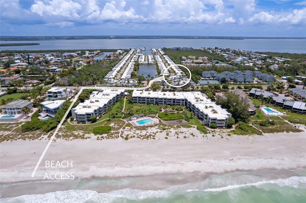 An aerial view shows beachfront condominiums with a swimming pool and a circled building area — 546 SPANISH DRIVE S, LONGBOAT KEY, FL