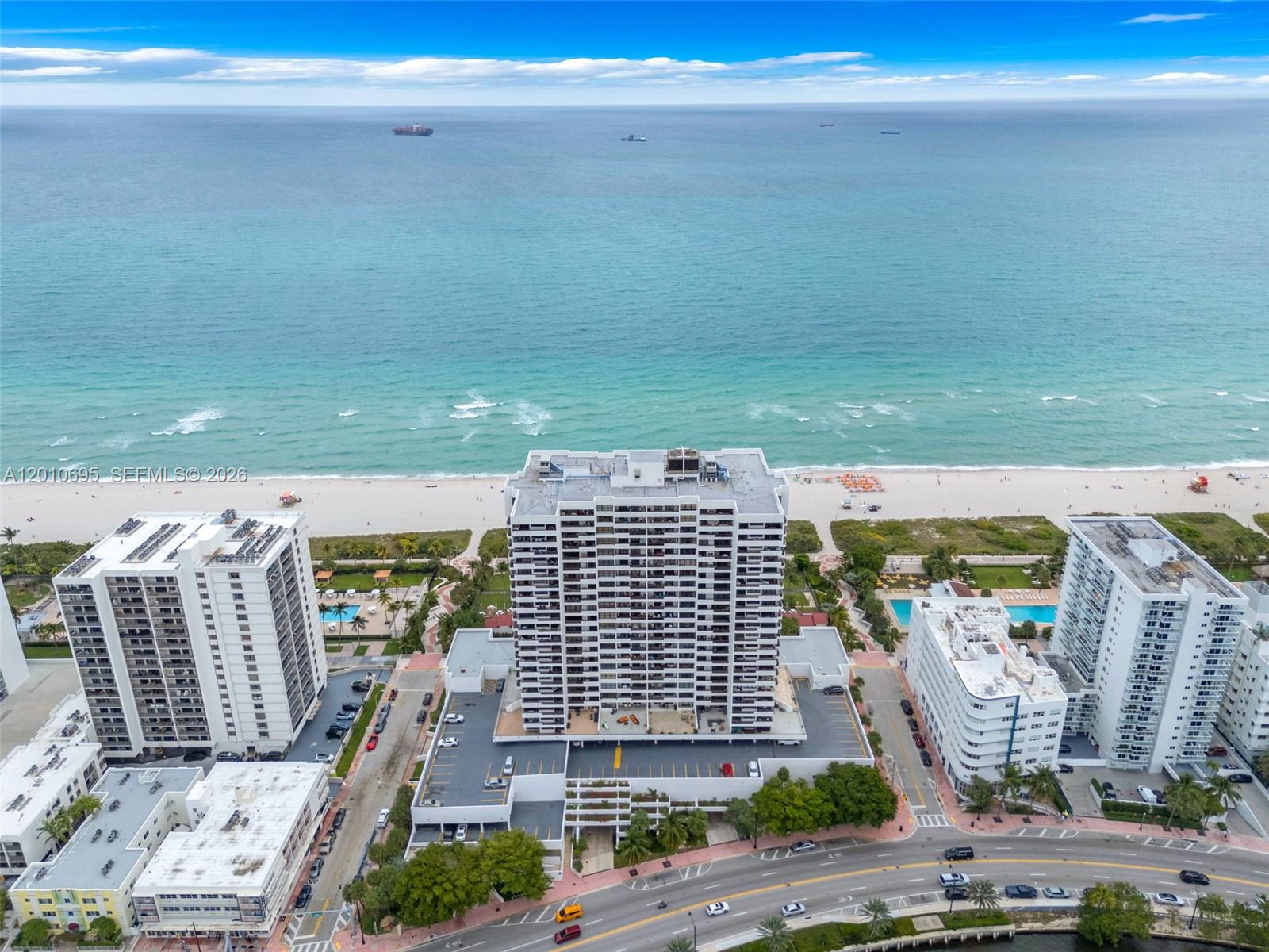 An aerial view shows a tall residential building situated between a beach and a road — 2555 Collins Ave # 2401, Miami Beach FL 33140, MIAMI BEACH, FL