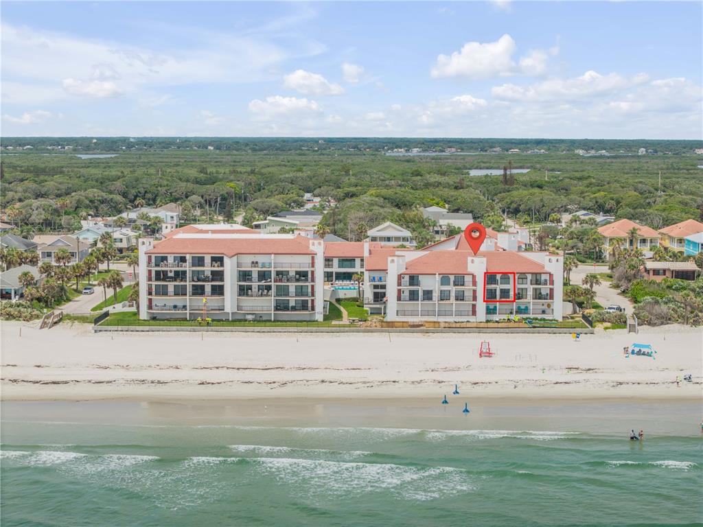 An aerial view of a multi-story beachfront condominium complex with a red location pin — 3001 S ATLANTIC AVENUE UNIT 305, NEW SMYRNA BEACH, FL