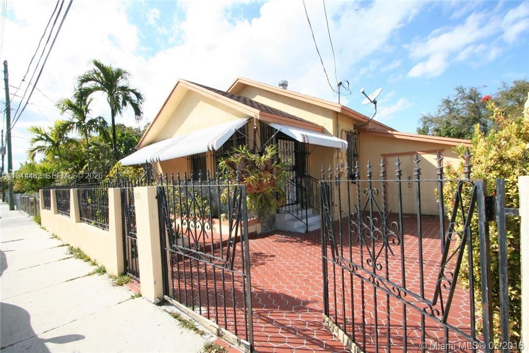 A single-story house with a red paved driveway and a black metal fence — 1119 SW 9th St, Miami FL 33130, MIAMI, FL