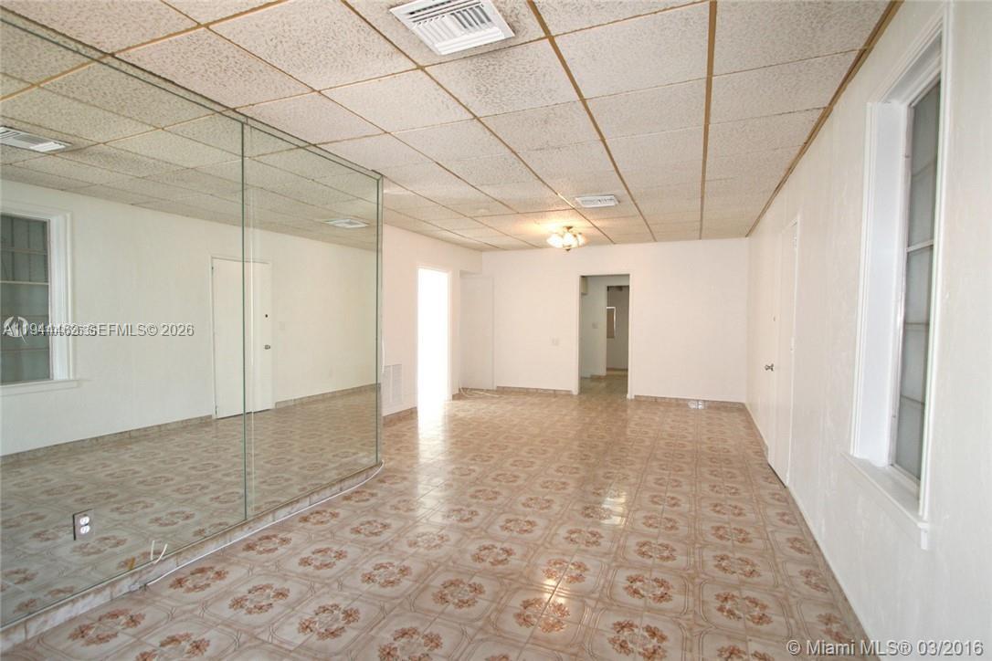 An interior room features a mirrored wall, tiled flooring, and a drop ceiling — 1119 SW 9th St, Miami FL 33130, MIAMI, FL