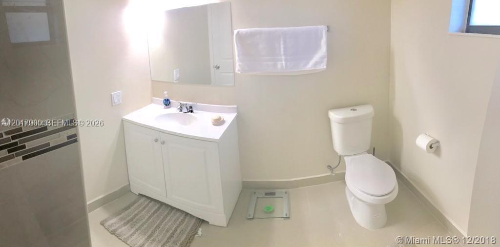 A bathroom features a white vanity, a toilet, a wall-mounted towel, and a glass scale — 11447 SW 33rd Ln # 0, Miami FL 33165, MIAMI, FL