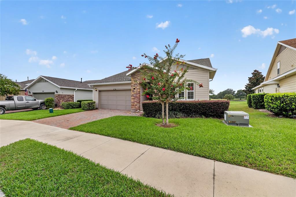 A single-story suburban house with a brick-accented facade, a two-car garage, and a manicured lawn — 4967 NW 35TH LANE ROAD, OCALA, FL