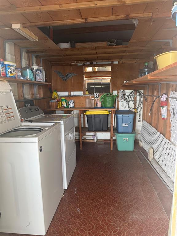 A laundry room with a washer and dryer, storage shelves, and a tiled floor — 2055 S FLORAL AVENUE UNIT 175, BARTOW, FL