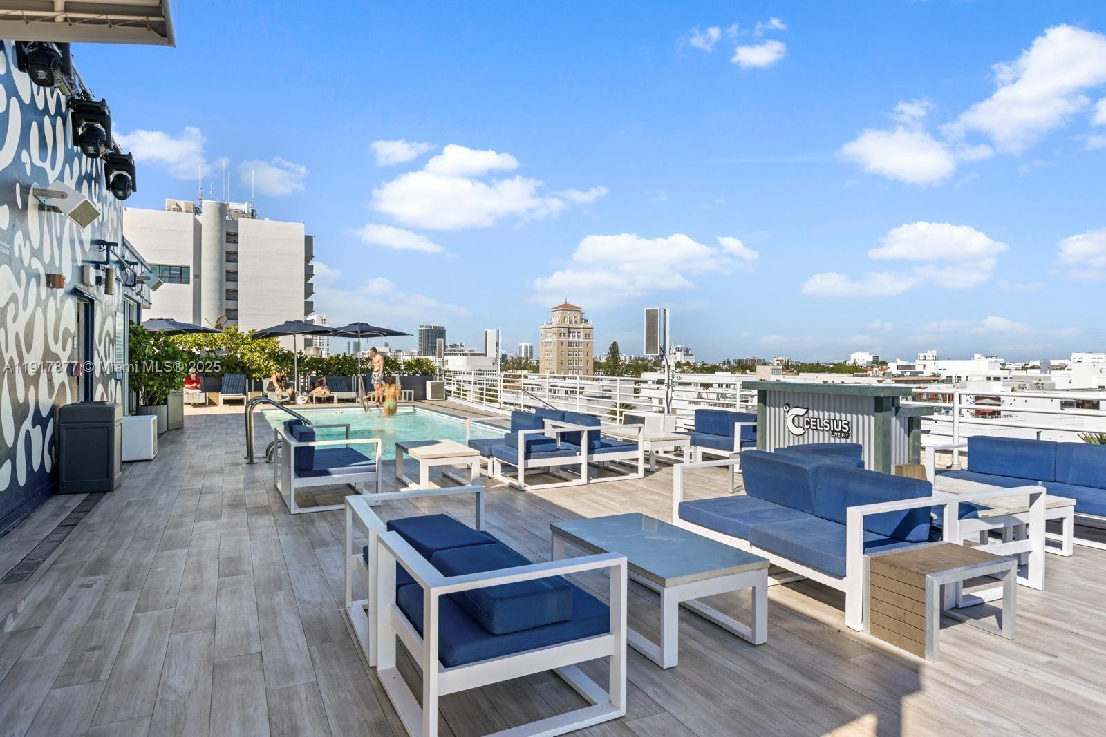 A rooftop terrace features a swimming pool, lounge seating, and city views under a blue sky — 1024 Ocean Dr # A502, Miami Beach FL 33139, MIAMI BEACH, FL