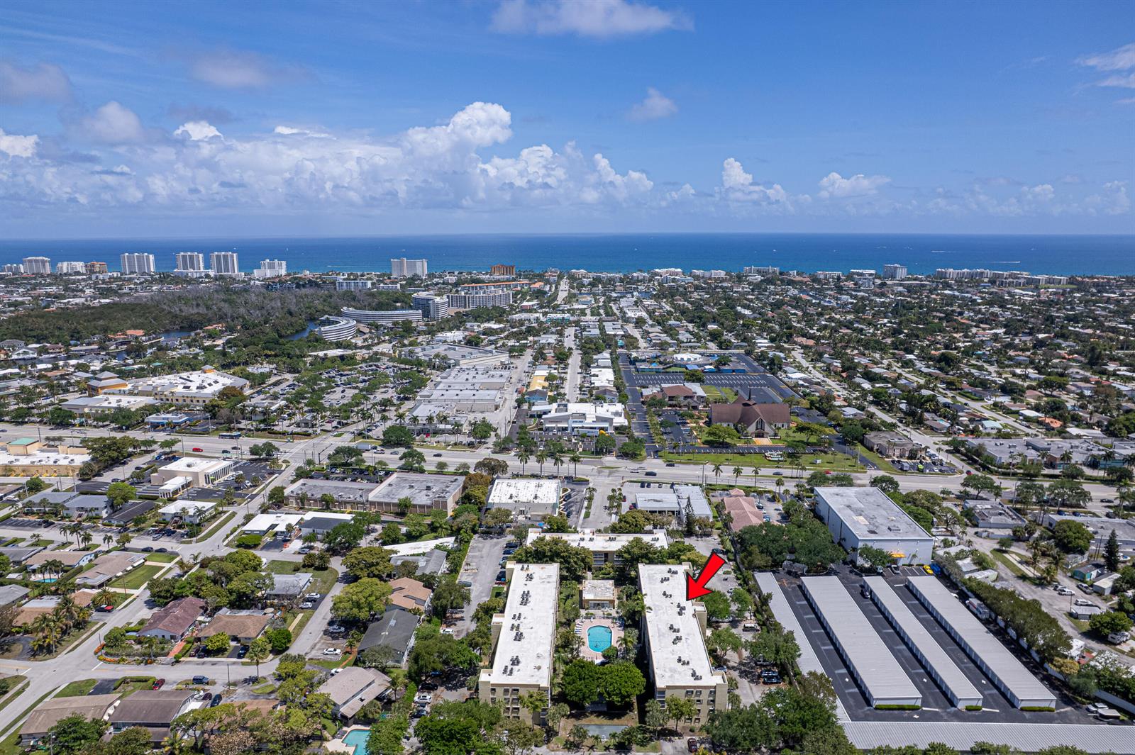 An aerial view shows two apartment buildings with a central pool and adjacent storage units — 367 S Federal Highway # C323, Deerfield Beach FL 33441, DEERFIELD BEACH, FL