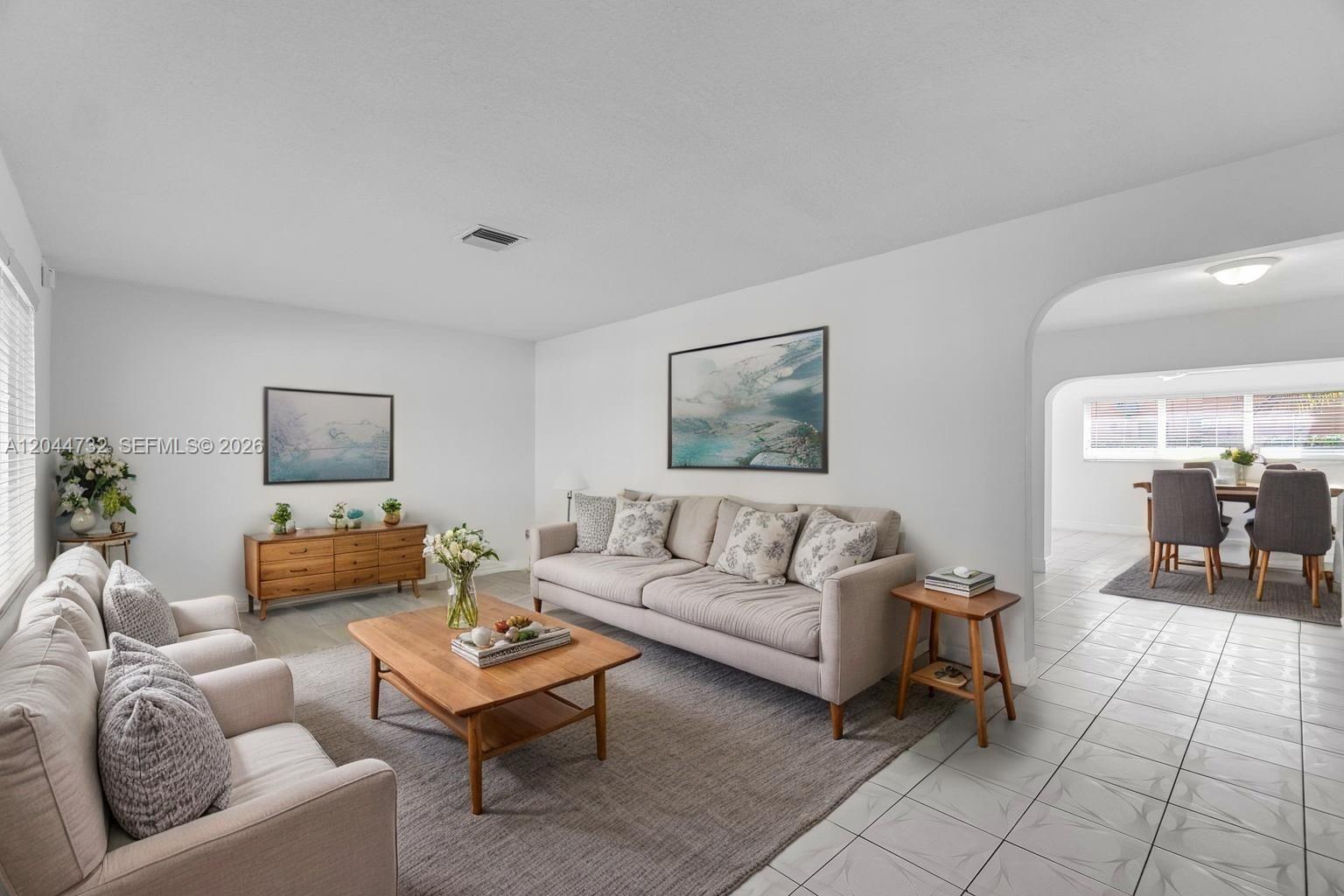 A living room features a beige sofa, two armchairs, a wooden coffee table, and tile flooring — 7125 SW 93rd Ct, Miami FL 33173, MIAMI, FL