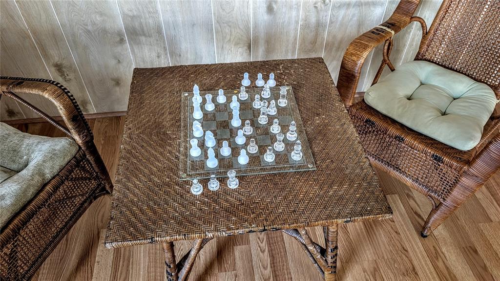 A glass chess set sits on a wicker table between two wicker chairs — 39820 US HIGHWAY 19 N UNIT 199, TARPON SPRINGS, FL