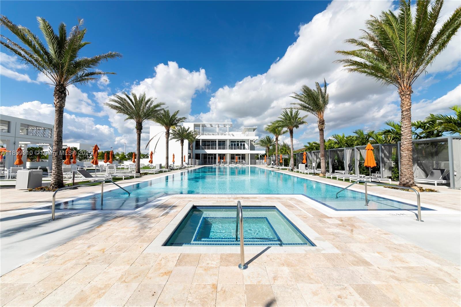 A swimming pool and hot tub are surrounded by palm trees and lounge chairs — 10245 NW 63rd Ter # 206, Doral FL 33178, DORAL, FL