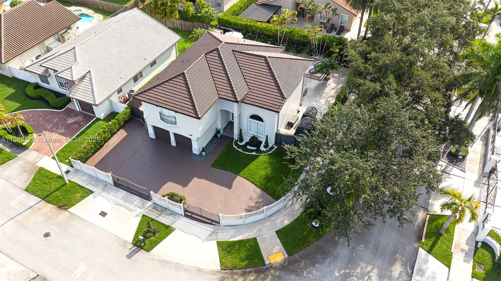 An aerial view shows a two-story house with a brown tile roof and driveway — 1385 SW 143rd Ct, Miami FL 33184, MIAMI, FL