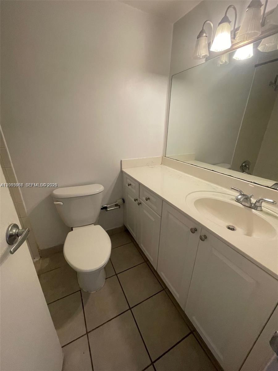 A bathroom features a white vanity, a toilet, and a large wall-mounted mirror — 1000 West Ave # 1122, Miami Beach FL 33139, MIAMI BEACH, FL