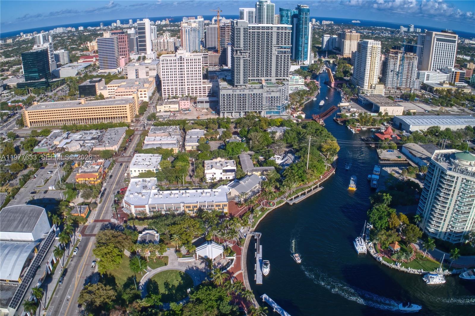 An aerial view of a city skyline, a river with boats, and a waterfront park — 1700 NW North River Dr, Miami FL 33125, MIAMI, FL