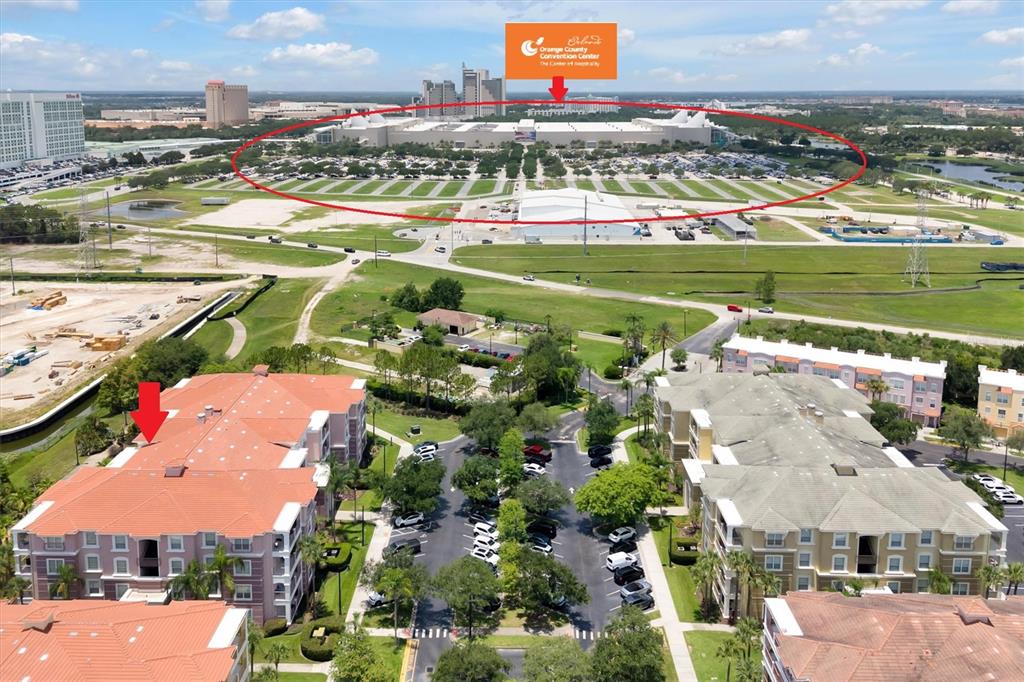 An aerial view shows apartment buildings in the foreground and the Orange County Convention Center — 5048 SHOREWAY LOOP UNIT 10204, ORLANDO, FL