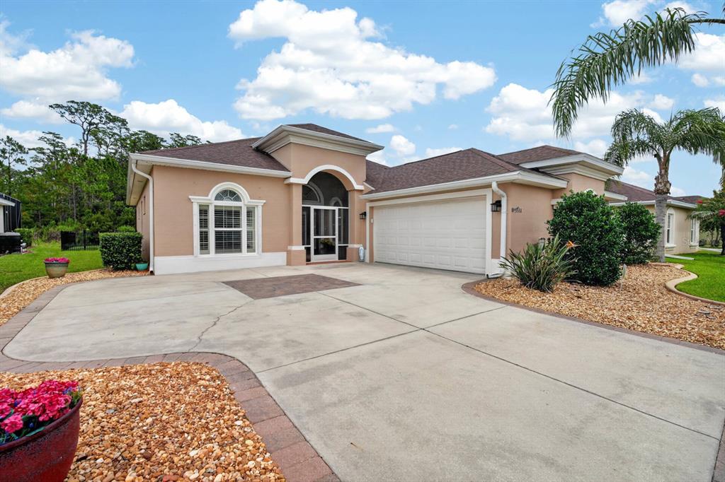 A tan single-story house with a two-car garage and a concrete driveway — 3331 BELLINO BOULEVARD, NEW SMYRNA BEACH, FL
