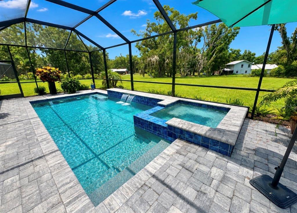 An aerial view of a single-story house with a paver driveway and a large lawn — 5322 124TH AVENUE E, PARRISH, FL