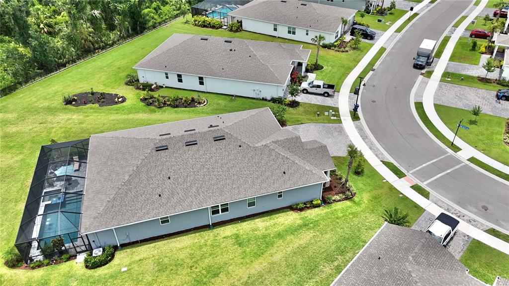 A single-story house with a gray exterior, a three-car garage, and a paved driveway — 5322 124TH AVENUE E, PARRISH, FL