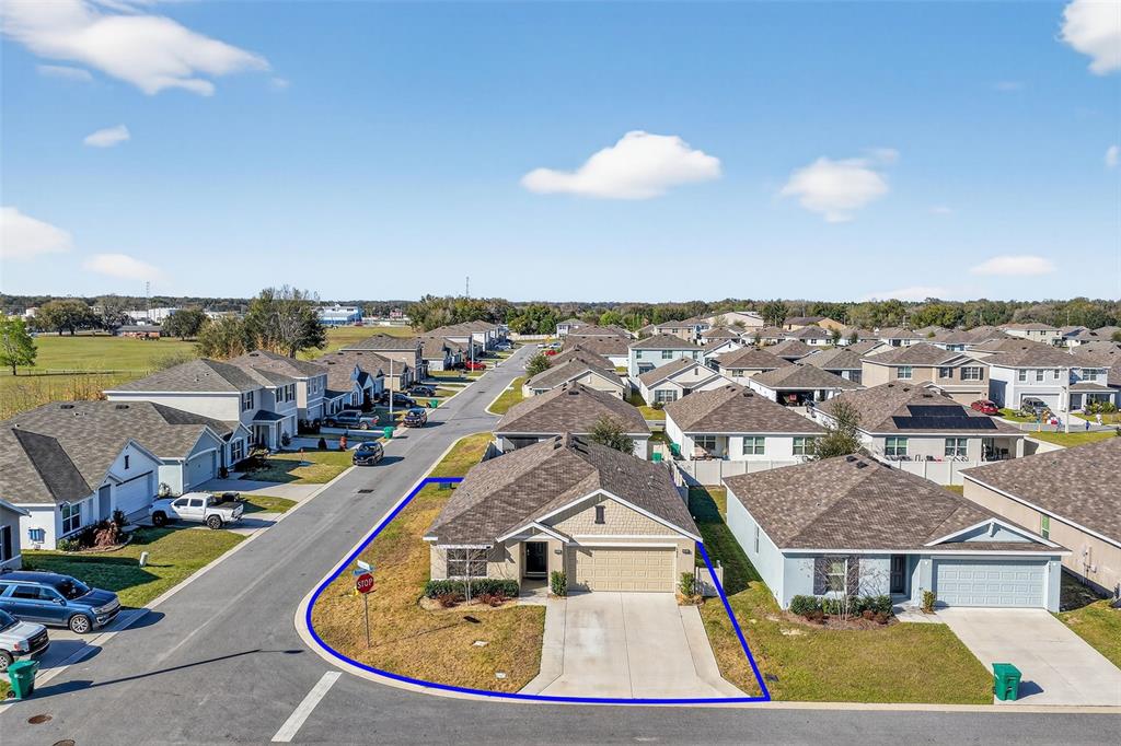 An aerial view shows a single-story suburban house with a blue outline on its lot — 4656 CROSSROADS LANE, WILDWOOD, FL