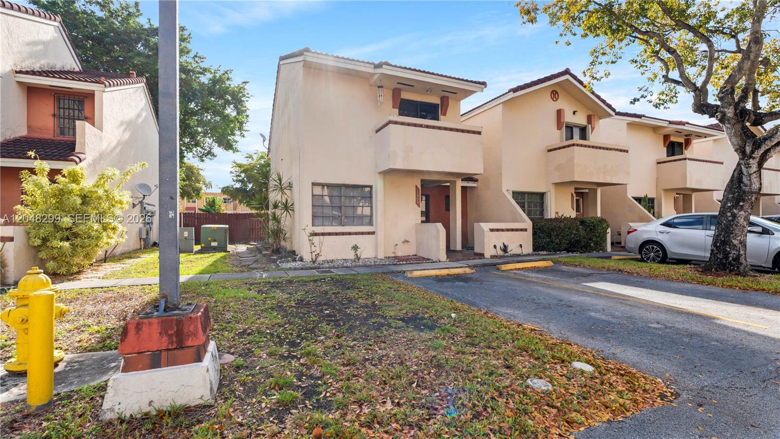 A room with white walls, light tile flooring, built-in shelving, and two windows — 17908 NW 68th Ave # 5, Hialeah FL 33015, HIALEAH, FL