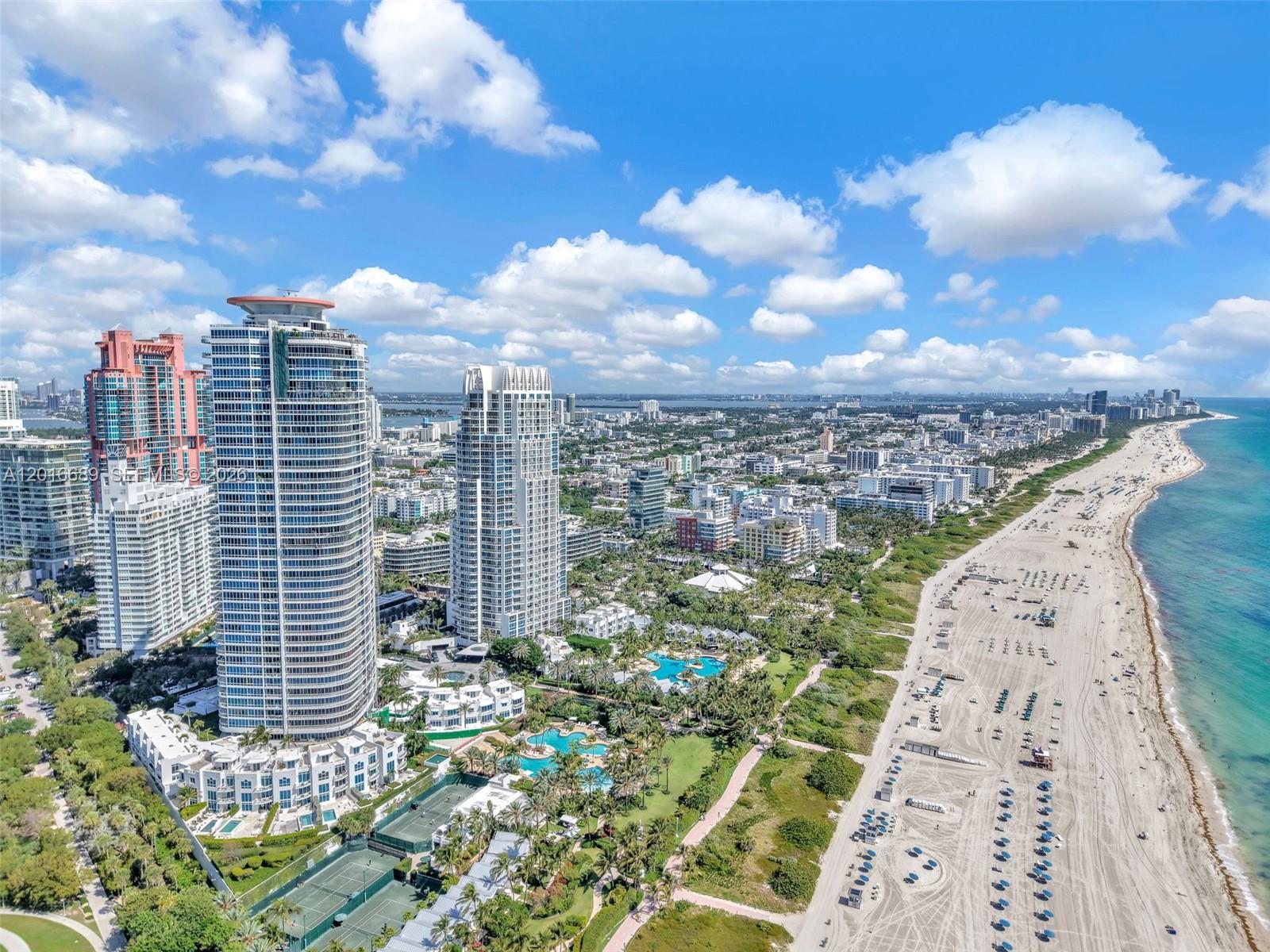 An aerial view of high-rise residential towers situated along a sandy beach and oceanfront — 100 S Pointe Dr # 801, Miami Beach FL 33139, MIAMI BEACH, FL