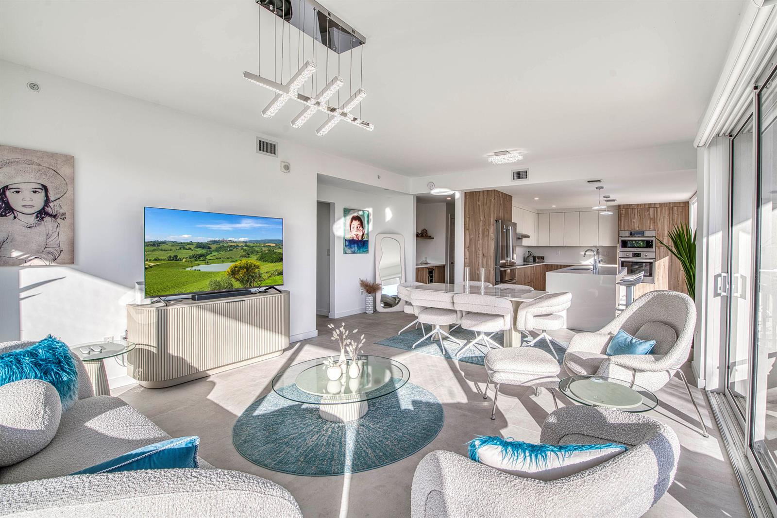 A modern open-concept living and dining room with white walls, light flooring, and contemporary furniture — 117 Lake Avenue # 204, FL 33460, FL