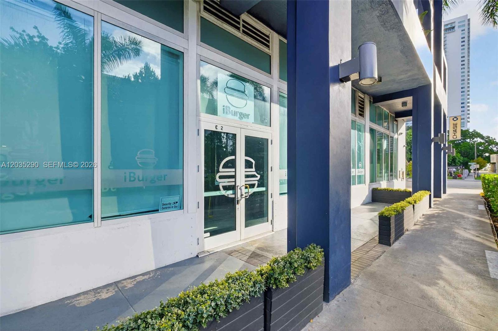 The exterior of a commercial storefront features glass doors and windows with iBurger branding — 275 NE 18th St, Miami FL 33132, MIAMI, FL