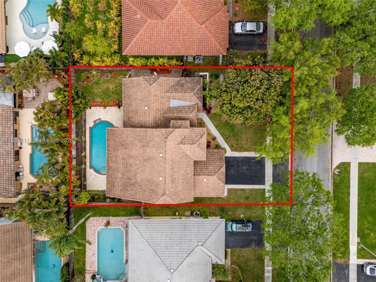 An aerial view shows a house with a tiled roof, a swimming pool, and a driveway — 1855 NW 106th Ter, Plantation FL 33322, PLANTATION, FL