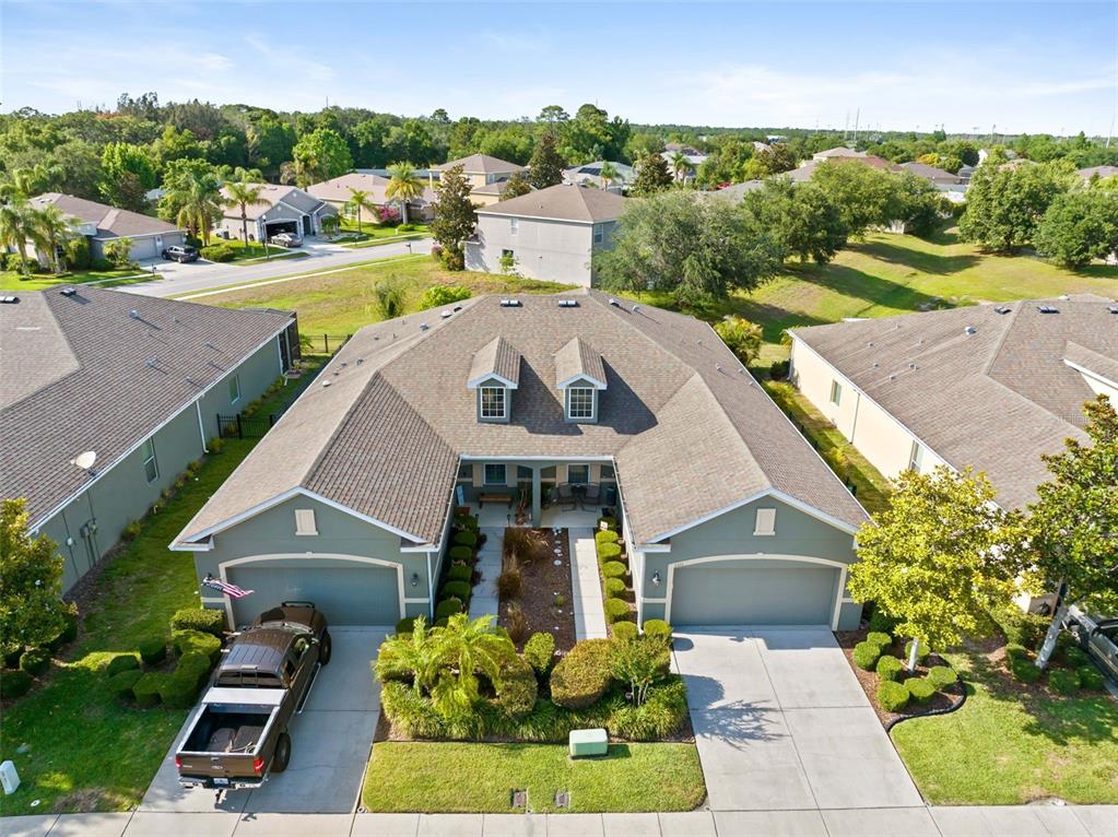An aerial view of a suburban house with two garages, a courtyard, and dormer windows — 2201 PARROT FISH DRIVE, HOLIDAY, FL