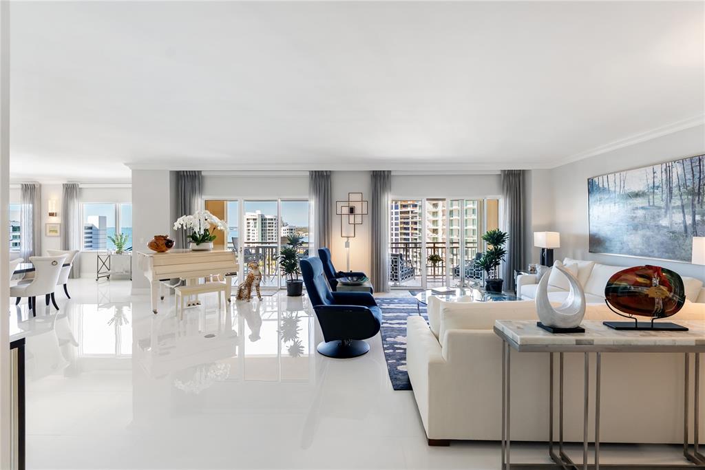 A bright living room features white tile floors, a grand piano, and floor-to-ceiling windows — 1111 RITZ CARLTON DRIVE UNIT 1603, SARASOTA, FL