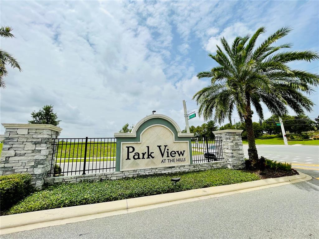 A stone-based monument sign for Park View at the Hills stands beside a palm tree — 367 LEMONGRASS ROAD, MINNEOLA, FL