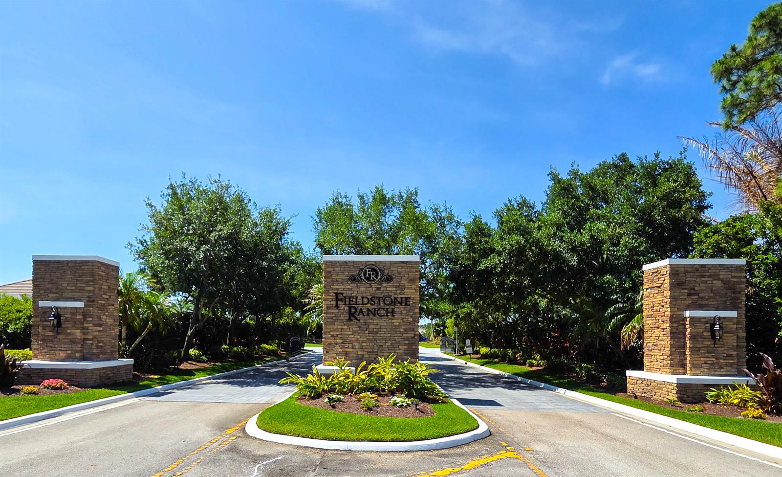 The entrance to Fieldstone Ranch features a stone monument sign flanked by two stone pillars — 7677 Fieldstone Ranch Square, Vero Beach FL 32967, VERO BEACH, FL
