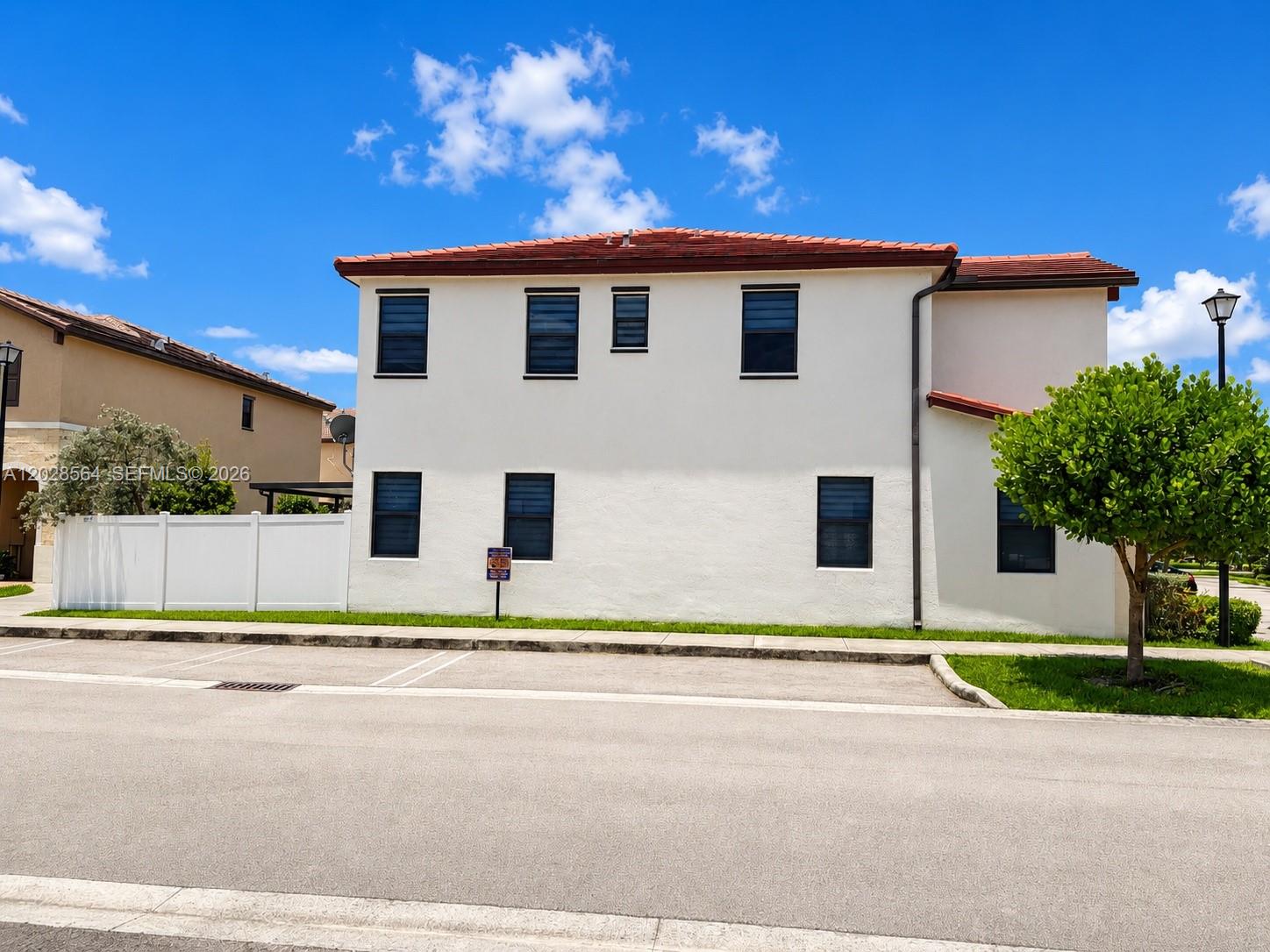 A two-story white stucco building with a red tile roof and dark-framed windows — 3368 W 105th Ter, Hialeah FL 33018, HIALEAH, FL
