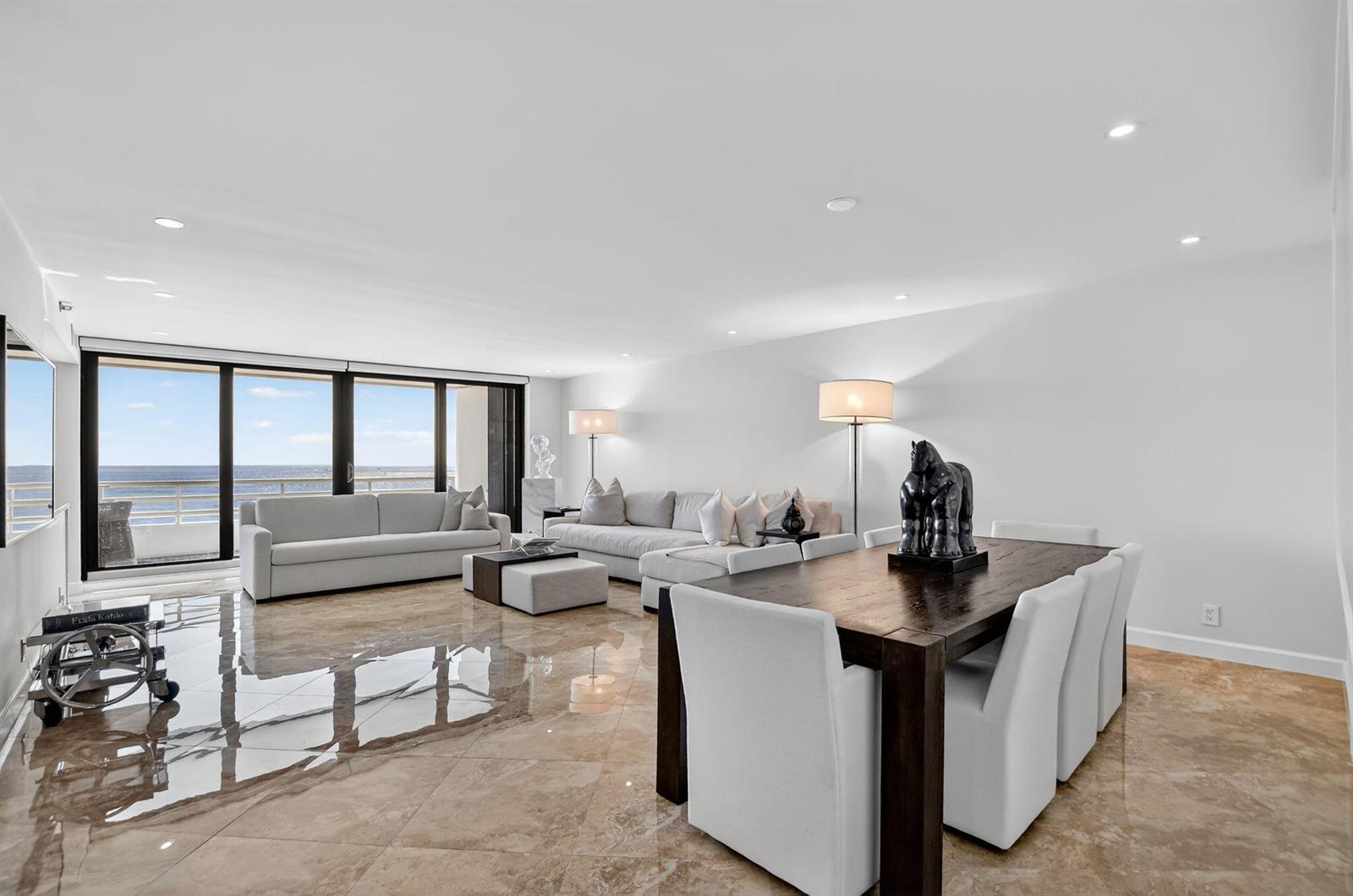 A bright, open-concept living and dining area features polished tile floors and floor-to-ceiling windows — 1500 S Ocean Boulevard # 704, Boca Raton FL 33432, BOCA RATON, FL
