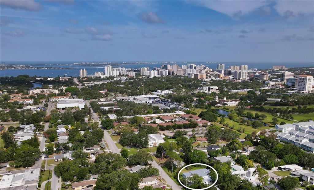 An aerial view of a residential neighborhood with a circled house in the foreground — 2231 WOOD STREET, SARASOTA, FL
