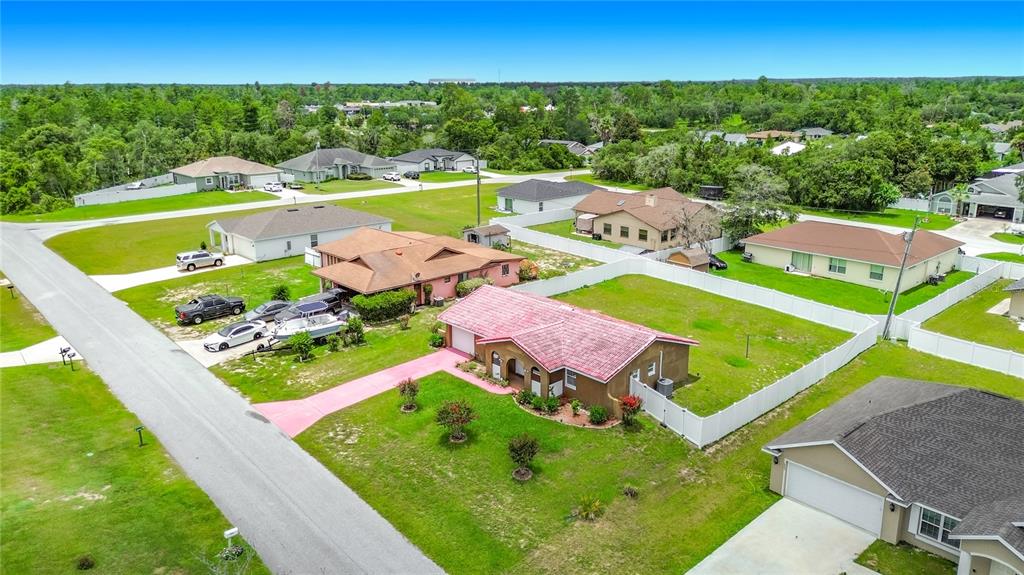An aerial view shows several suburban houses with yards and driveways in a residential neighborhood — 2939 SW 144TH PLACE ROAD, OCALA, FL