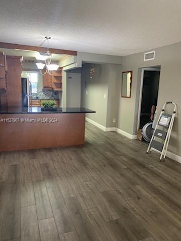 A kitchen with a breakfast bar, wood cabinets, and light-colored wood-look flooring — 5500 SW 77th Ct # 201, Miami FL 33155, MIAMI, FL