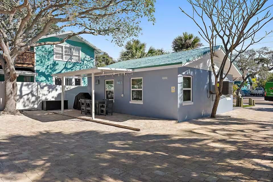 A single-story gray house with a covered patio and a paved driveway — 724 GULF BOULEVARD, INDIAN ROCKS BEACH, FL