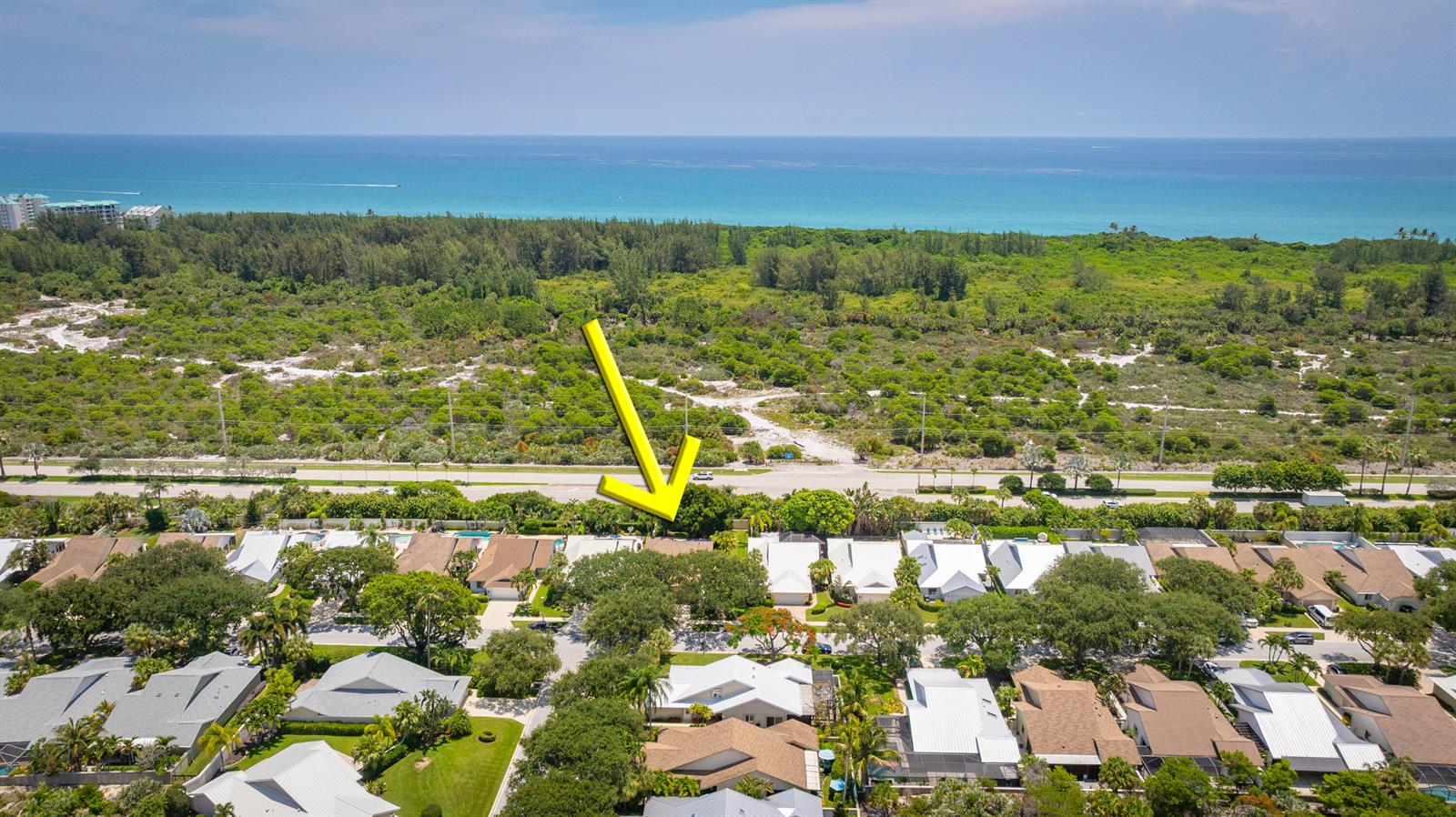An aerial view shows a residential neighborhood with a yellow arrow pointing to a house — 137 Seashore Drive, Jupiter FL 33477, JUPITER, FL